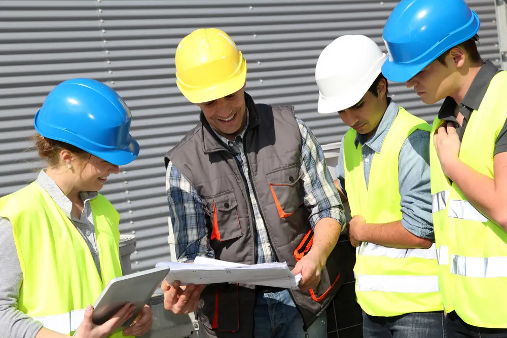 Webb's Training people in hard hats with crane in background